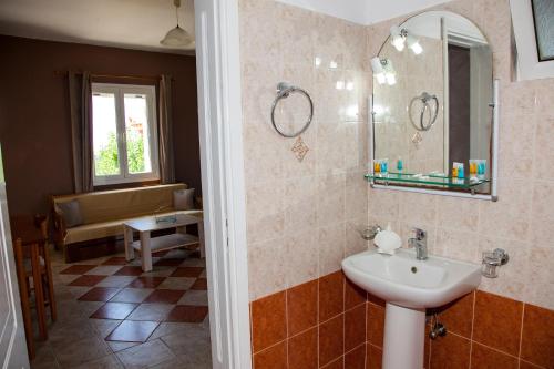 a bathroom with a sink and a mirror at Maspali Apartments in Lixouri