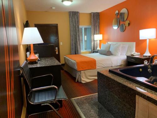 a hotel room with a bed and a bath tub at Howard Johnson by Wyndham North Bergen in North Bergen