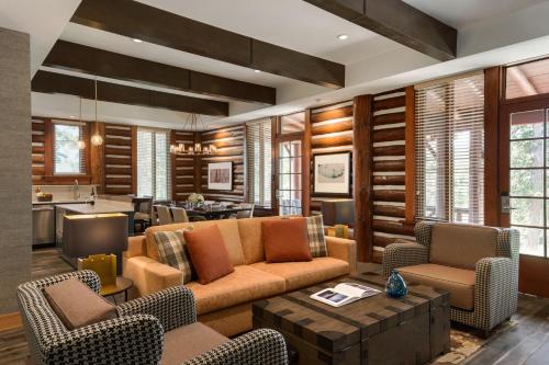 a living room with a couch and chairs at Fairmont Jasper Park Lodge in Jasper