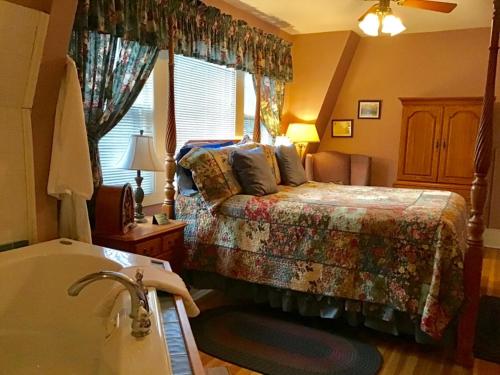 a bedroom with a bed and a bath tub at Brookview Manor Inn in Canadensis