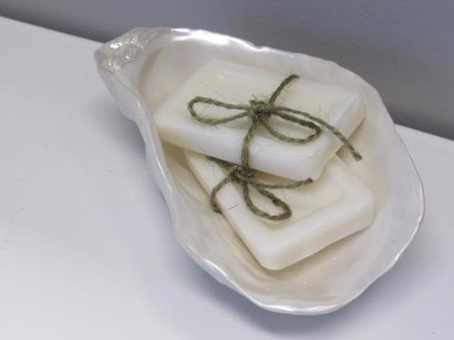 a piece of soap sitting on a white plate at Inner Joy Getaways in Elora
