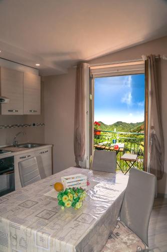 a kitchen with a table with a view of a balcony at Tramonti di Sole in Tramonti