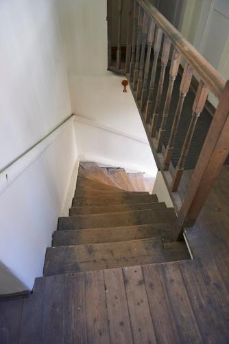 a staircase with wooden floors and a wooden railing at Very Vilnius Pilies street in Vilnius