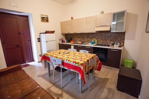 a kitchen with a table with a table cloth on it at Apartment Eutime- in Locri