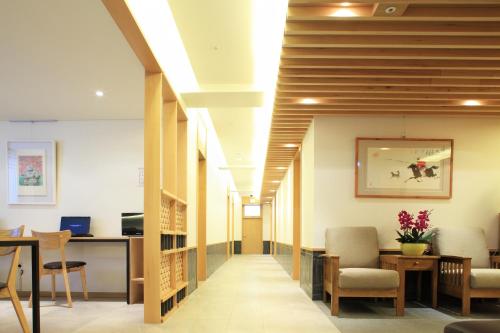 a hallway of a hospital with chairs and a table at Dream House in Seoul