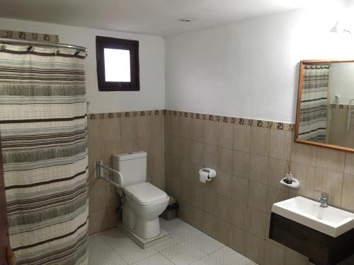 a bathroom with a toilet and a sink at Cabañas Ernes Huasi in Tafí del Valle