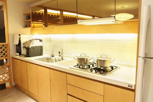 a kitchen counter with two pots on a stove at Dream House in Seoul