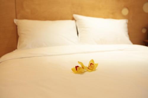 a white bed with a flower on it at Dream House in Seoul