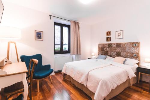 a bedroom with a bed and a desk and a desk at Second Life in Piran - Hotel Zala Piran with private parking and shuttle service in Piran