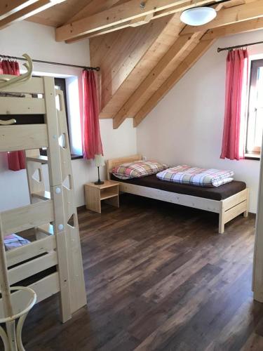 a room with two bunk beds and a ladder at Apartmány Verunka in Kvilda