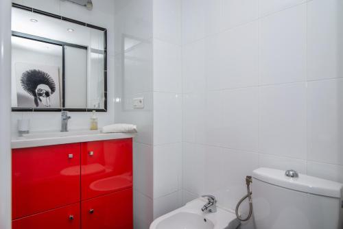 a bathroom with a red cabinet and a white toilet at Appart' Vieil Antibes in Antibes