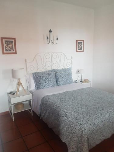 a bedroom with a bed and a lamp on a table at Casas La Torre in Isora