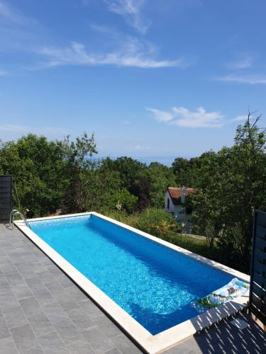 a swimming pool with a view of a house at Villa Lella in Rukavac