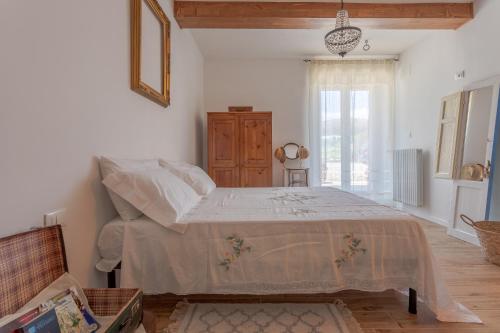 a bedroom with a bed in a room with a window at Panfilo Farmhouse in Cellino Attanasio