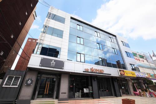 a large building with glass windows on a street at Dream House in Seoul