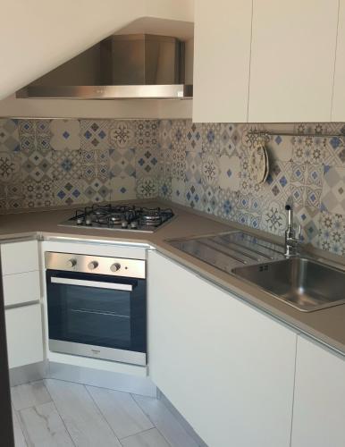a kitchen with a stove and a sink at Casa Le Site con giardino in Palmariggi