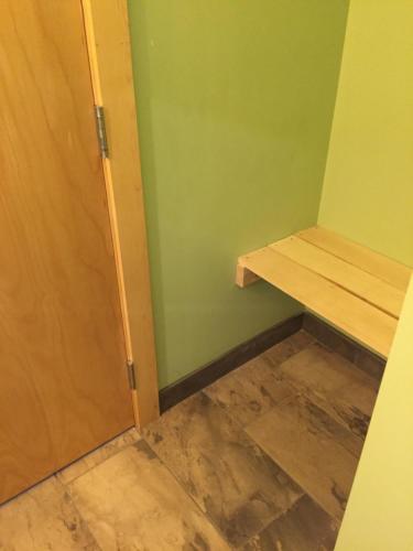 a room with a door and a wooden shelf at Hostel du Nord in Duluth