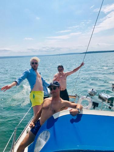 three men on a boat in the water at Hostel du Nord in Duluth