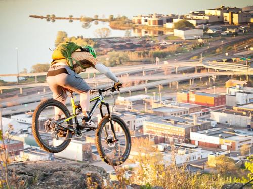 a person doing a trick on a bike on a rock at Hostel du Nord in Duluth