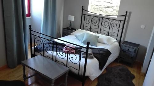 um quarto com uma cama preta e uma janela em Azoka by the Sea- Centro Histórico de Peniche em Peniche