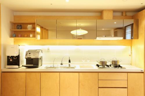 a kitchen with a sink and a stove top oven at Dream House in Seoul