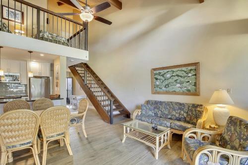 a living room with a couch and chairs and a table at Alea Condo in Kahuku