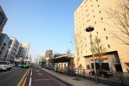 an empty street in a city with buildings at Dream House in Seoul