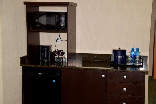 a kitchen with a counter top with a microwave at Coast Lethbridge Hotel & Conference Centre in Lethbridge