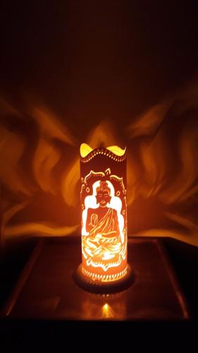 a candle that is on top of a table at Mandacaru Guest House in Praia do Forte