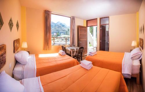 Giường trong phòng chung tại Le Foyer Colca