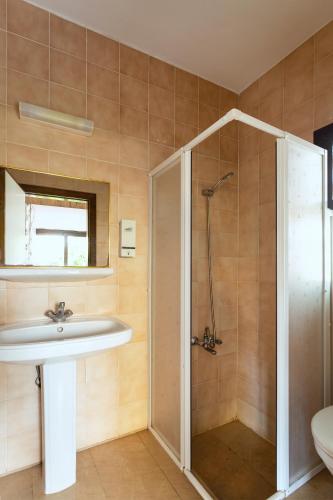 a bathroom with a sink and a shower at Kabasakal Otel in Çeşme