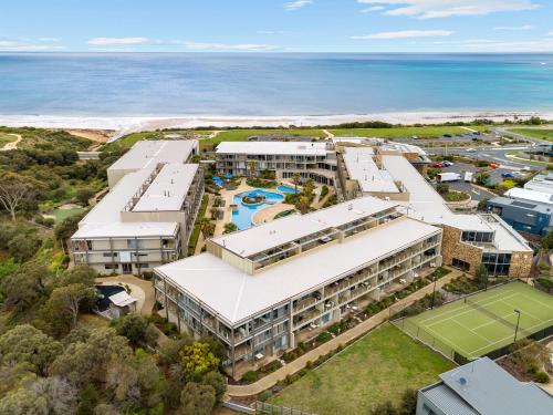 an aerial view of a resort with a tennis court at Wyndham Resort Torquay in Torquay