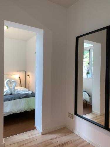 espejo en un dormitorio con cama en New City Garden view 5min TU Delft central room bentley utopia, en Delft