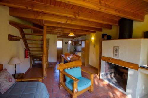 a living room with a staircase and a fireplace at Gradocero in San Carlos de Bariloche