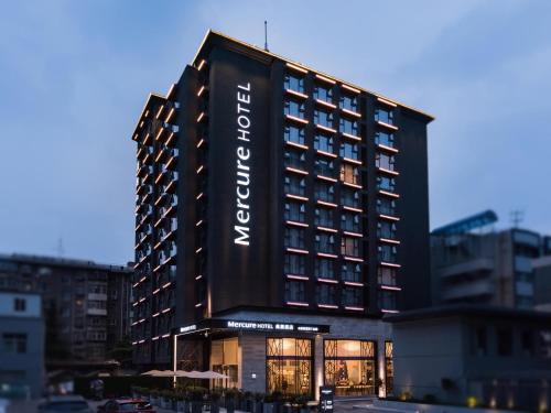 a tall black building with a sign on it at Mercure Xi'an Downtown in Xi'an