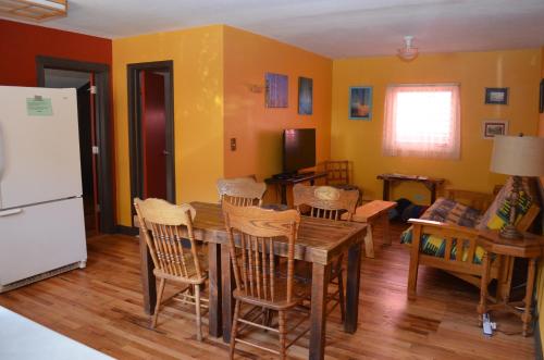 eine Küche mit einem Tisch und Stühlen sowie einem Kühlschrank in der Unterkunft The Ouray Main Street Inn in Ouray