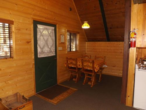 a dining room with a table and a green door at Arizona Mountain Inn & Cabins in Flagstaff