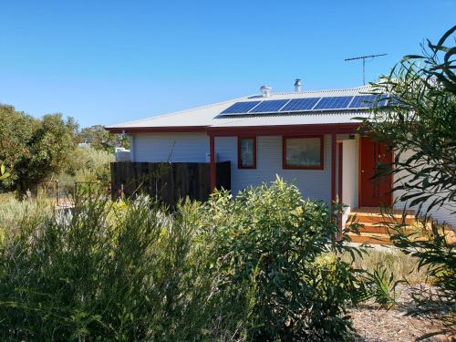 a house with solar panels on the roof at Samphire: Coorong Accommodation in Meningie