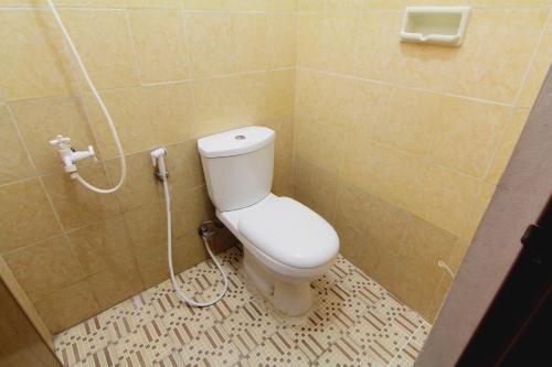 a bathroom with a toilet and a shower at Wanderlust Homestay in Yogyakarta