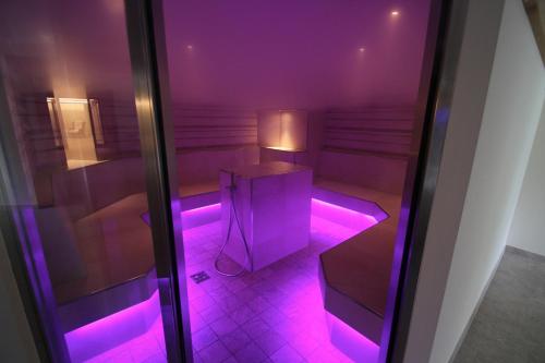 a room with a purple light in a room at Familienhotel Christoph in Ellmau