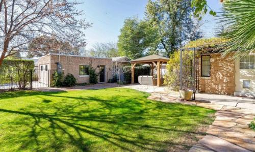 a backyard with a brick house and a grass yard at Best Little Guesthouse in Melrose! New Listing! in Phoenix