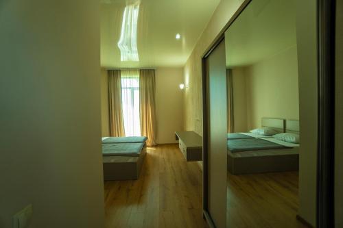a small room with two beds and a mirror at Twins in Anaklia