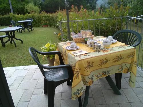 a table with a yellow table cloth on top of it at B&B Oasi Verde in Corvara