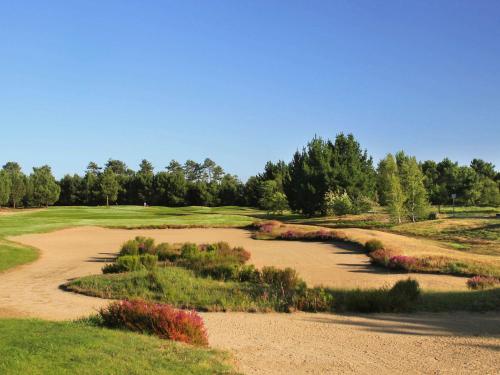 a view of a golf course with a dirt road at Cabot Hotel Bordeaux - MGallery Collection in Le Pian-Médoc