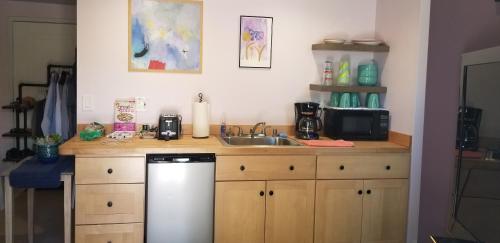 a kitchen with a sink and a counter with a dishwasher at Best Little Guesthouse in Melrose! New Listing! in Phoenix