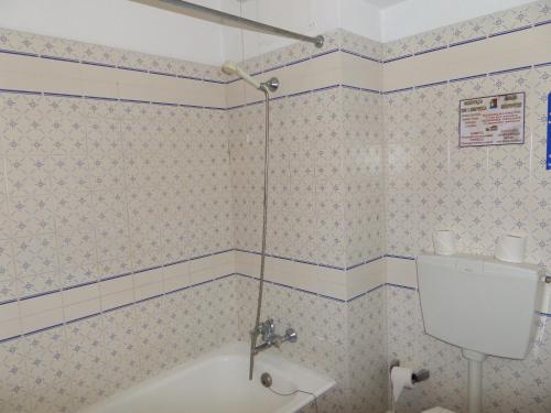 a bathroom with a shower with a toilet and a sink at Apartamentos Turisticos Silchoro in Albufeira