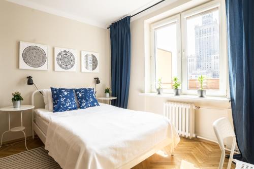 a white bedroom with a bed and a window at ★Bright, spacious apartment|Palace of Culture view★ in Warsaw