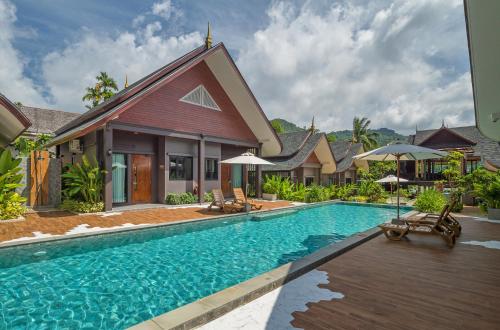 a swimming pool in front of a villa at The Scene Cliff View Villas in Ao Nang Beach