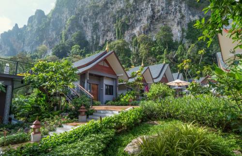 a row of houses in front of a mountain at The Scene Cliff View Villas in Ao Nang Beach
