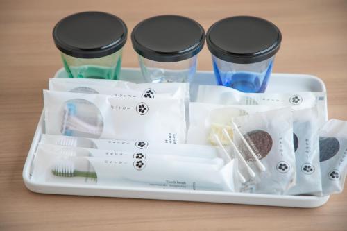 a tray with three cups and utensils at Narita AIC Airport Hotel in Narita